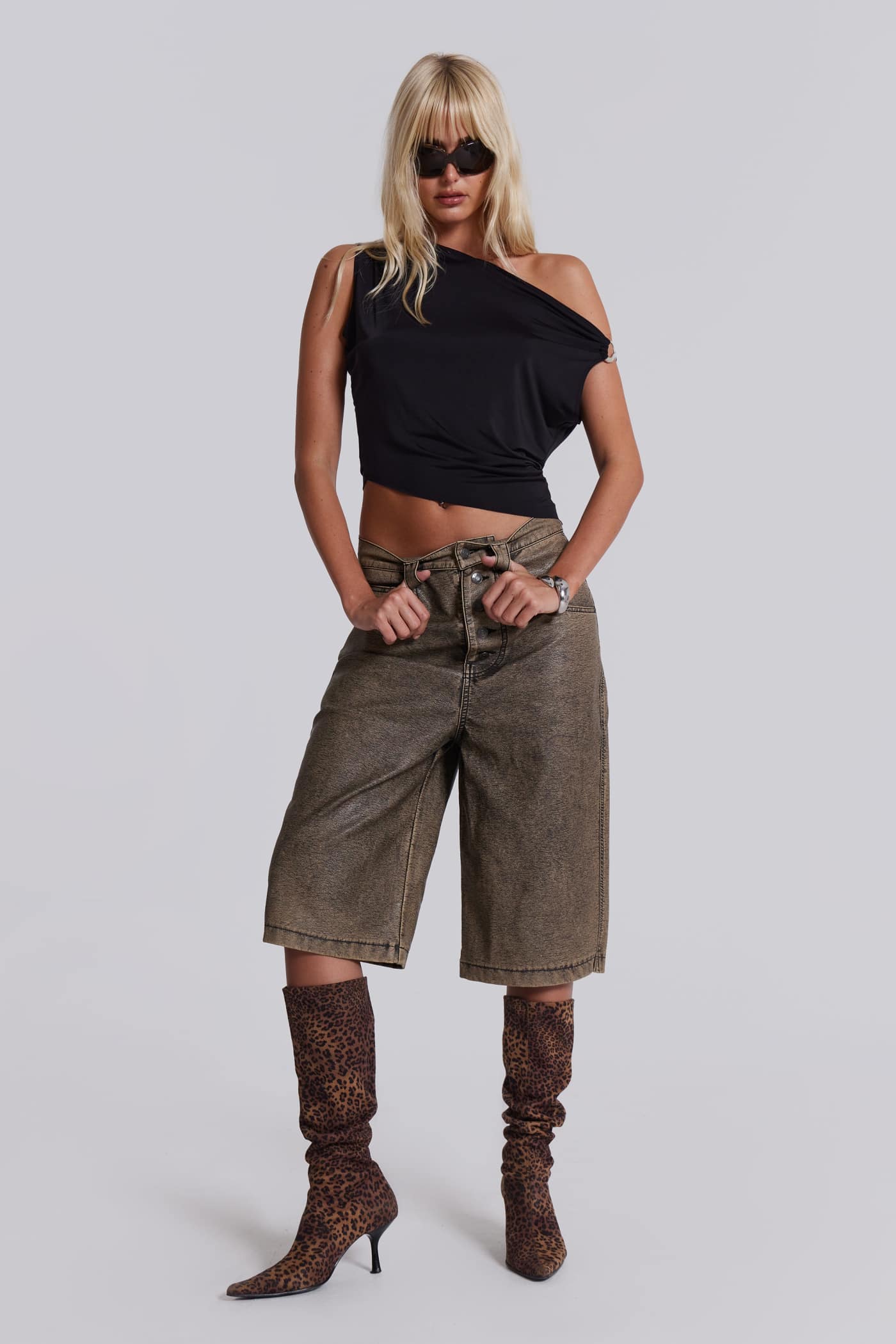 Female model wearing brown faux leather jorts.