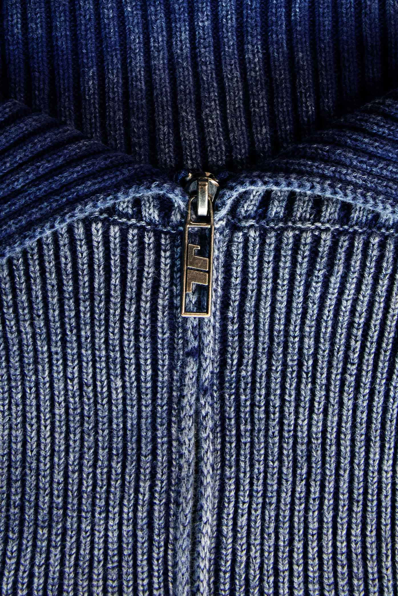 Female wearing blue denim look chunky wide rib knitted long sleeve off the shoulder top. 