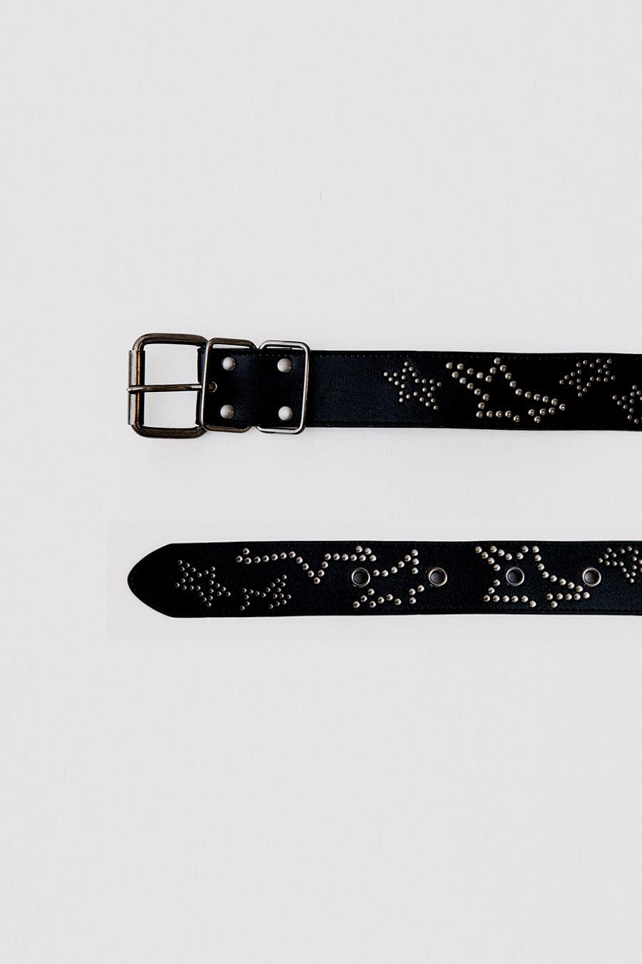 This black leather belt features silver start studded detail. 