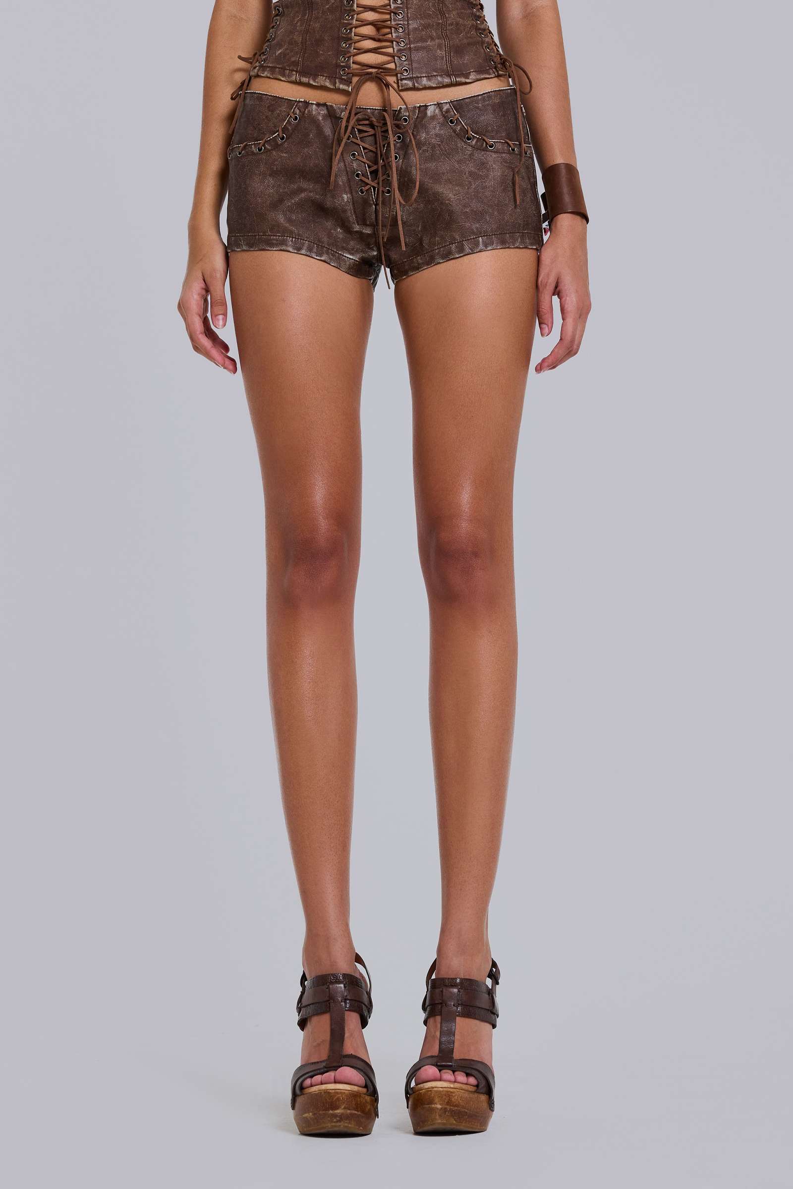 Vaca Whipstitch Faux Leather Mini Shorts in Brown